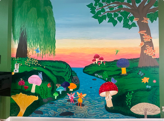 GPLXC mural featuring a river, mushrooms, and fairies inside the cultural center