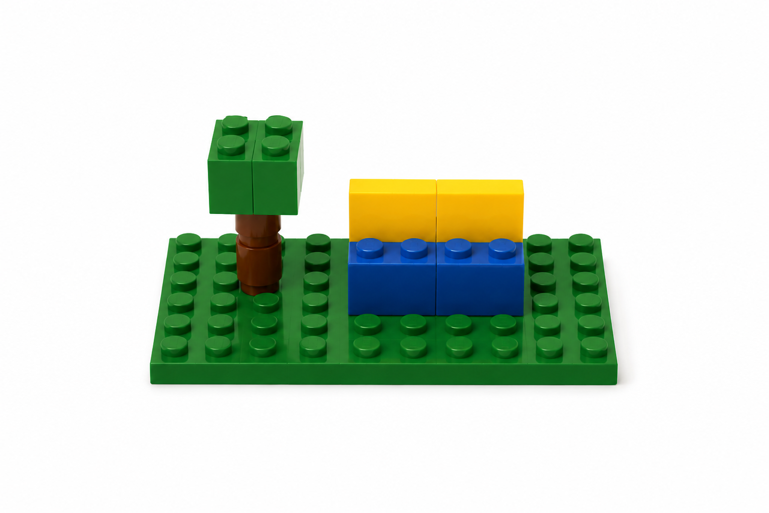LEGO quiet space with a small tree and blue and yellow seating on a green baseplate